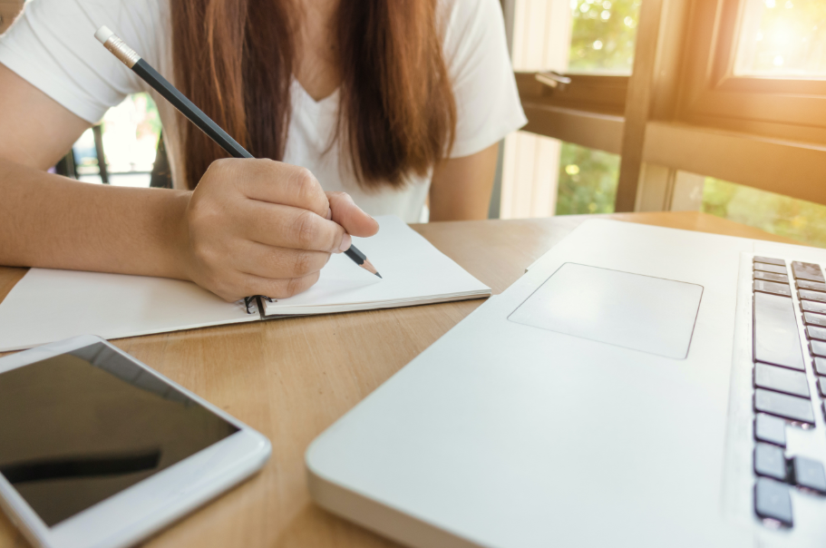 girl writing on notebook